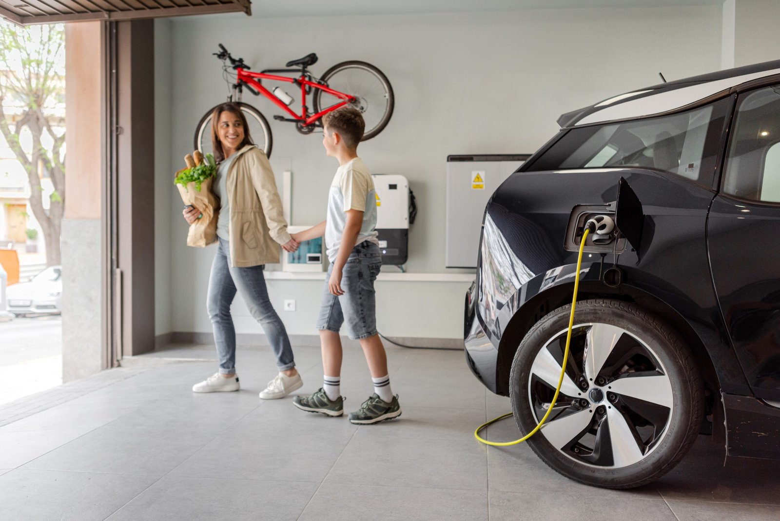 Happy,Son,And,Mother,Plug,Ev,Charger,From,Home,Charging EV Charging Stations